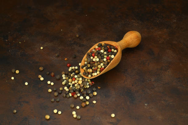 istock Pepper mix in scoop isolated on rusty background, top view 1343653494