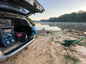 Breakfast in overlanding campsite by calm lake