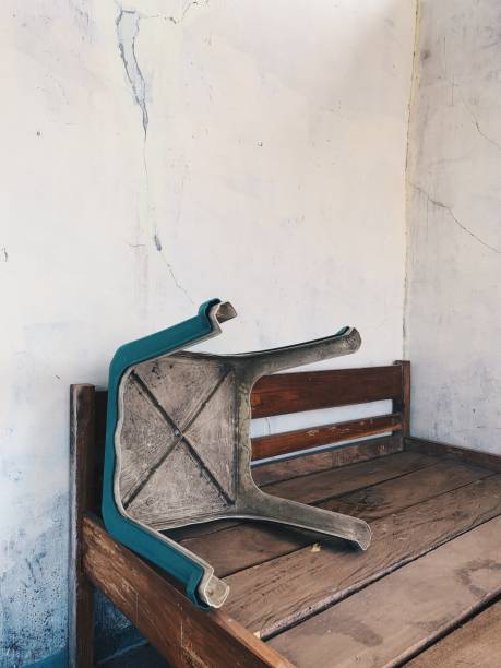 An old chair and a crumbly frame Old things can't be used anymore. This photo was taken in Indonesia. funeral home chairs stock pictures, royalty-free photos & images