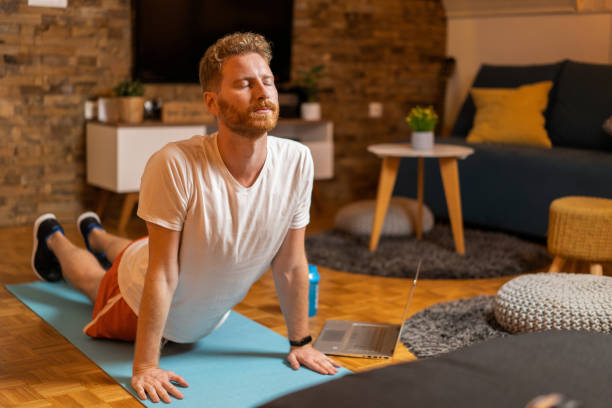 istock Young man exercising at home. 1343658629