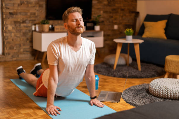 istock Young man exercising at home. 1343658638