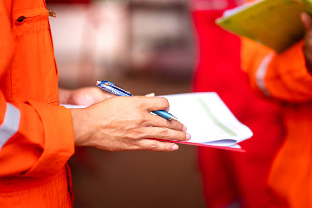 istock Writing on checklist paper during commissioning audit - Operational group meeting action. 1343663540