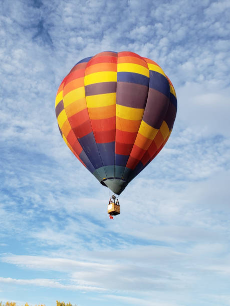 istock Vibrant colored hot air balloon in flight 1343664669