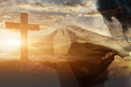 Double exposure of child girl clasp hand worship and praise God at sunset background. Christian Religion concept.