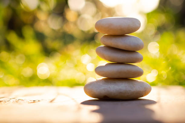 istock Pyramid pebbles on wood outdoor nature blur bokeh background. 1343671707