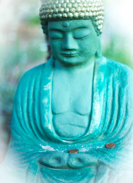 istock Green Buddha Statue with Pennies Close-Up 1343673470