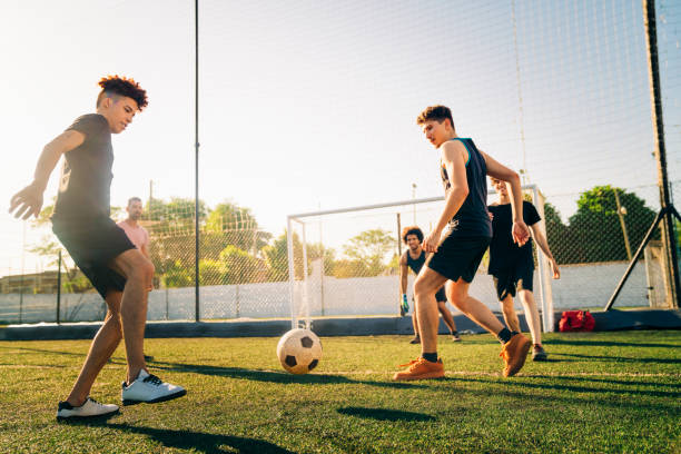 istock Male athletes playing soccer during sunny day 1343674399