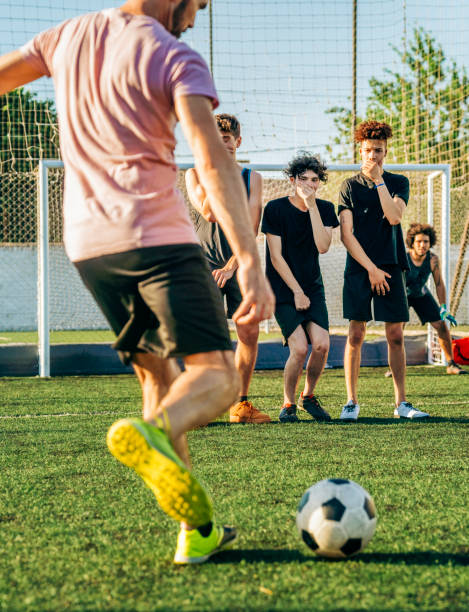 istock Mature man kicking ball during penalty kick 1343674717
