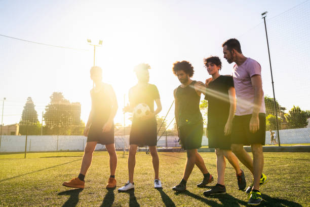 istock Male players walking at field on sunny day 1343674749
