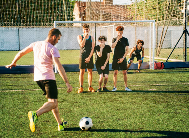 istock Male player kicking ball during penalty kick 1343674791