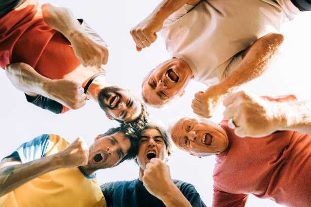 istock Shouting male athletes making fists while huddling 1343674862
