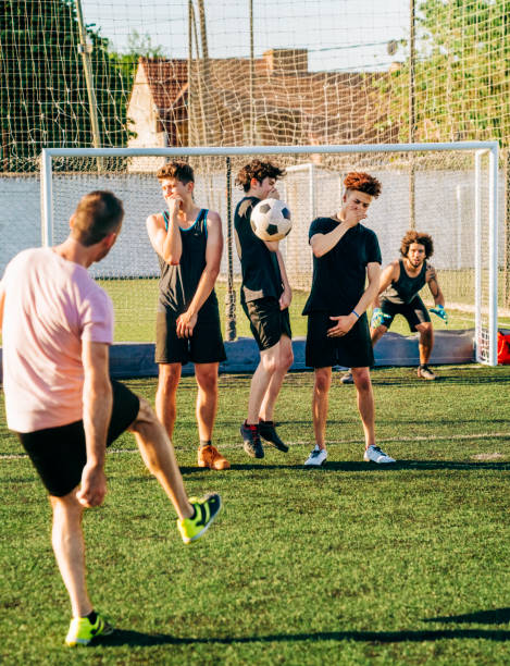 istock Male player kicking ball during free kick at field 1343674883