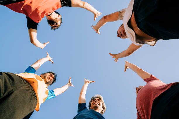 istock Male athletes with arms raised during sunny day 1343674888