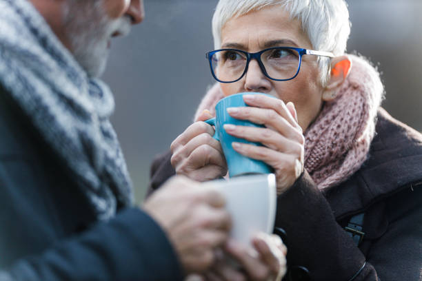 istock Senior couple drinking hot drink in nature. 1343682739