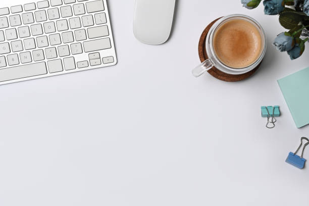 istock Above view cup of coffee, sticky note and keyboard on white table. 1343688798