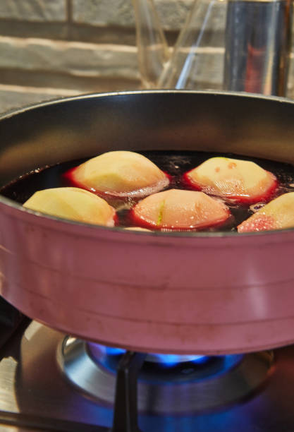 istock Pears are boiled in red syrup with wine on gas stove 1343688872