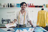 Cheerful fashion designer holding color swatches