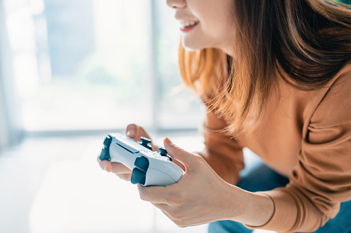 Woman hand playing a computer games with joystick