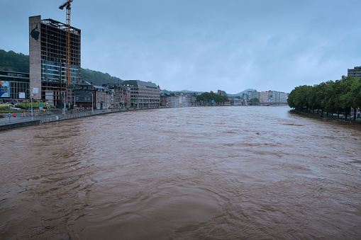 Liège, Belgium - July 15, 2021: River Meuse reaches the maximum deck capacity, imminent flood in the city of Liège.