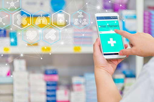 Pharmacist using mobile smart phone for search bar on display in pharmacy drugstore shelves background. Online medical concept