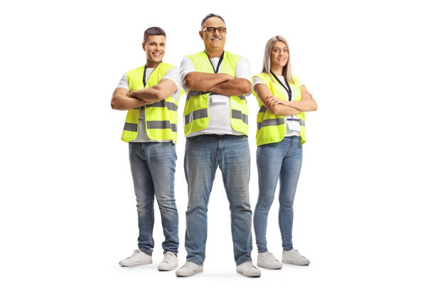 Full length portrait of two men and a woman wearing a reflective safety vests and posing with crossed arms Full length portrait of two men and a woman wearing a reflective safety vests and posing with crossed arms isolated on white background waistcoat stock pictures, royalty-free photos & images