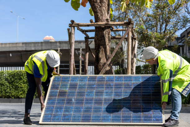 Solar cell workers working on installing solar panel on the rooftop of the house for renewable energy and environmental friendly outcome
