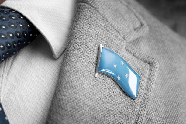 metal badge with the flag of federated states micronesia on a suit lapel - lapel brooch badge suit imagens e fotografias de stock
