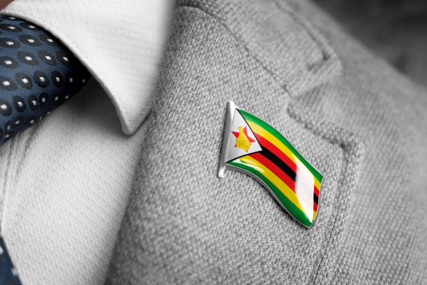 metal badge with the flag of zimbabwe on a suit lapel - lapel brooch badge suit imagens e fotografias de stock