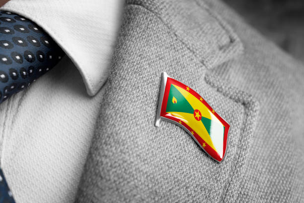 metal badge with the flag of grenada on a suit lapel - lapel brooch badge suit imagens e fotografias de stock