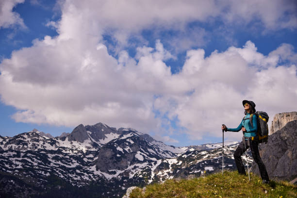 istock Female hiker with backpack relaxing and enjoying the view 1343712506