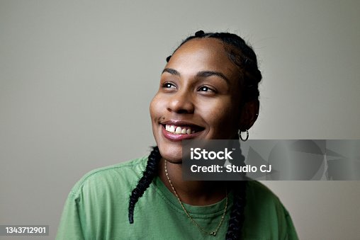 istock Portrait of young smiling woman with braids in her hair. 1343712901