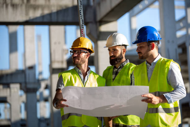 istock Business building teamwork people concept. Group of engineer with blueprint on construction site 1343714032