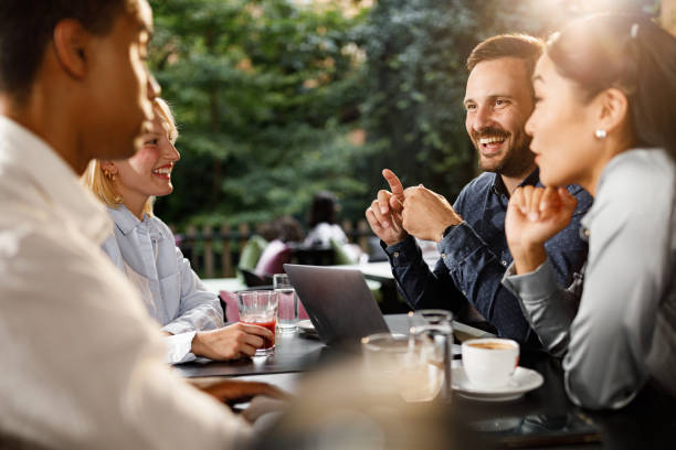 istock Happy business colleagues communicating while working in a cafe. 1343723341
