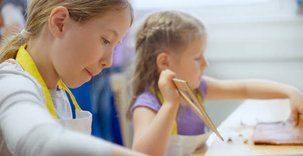 istock Girls making clay birdhouse 1343742214