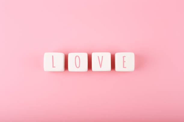 istock Word love written on white toy cubes against pink background with copy space 1343745908