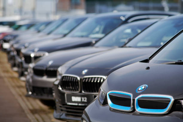 New BMW cars for sale Neuss, Germany- Sept., 28, 2021: Row of new BMW cars in front of car dealer. The first car is an electric i3, the second a X2. bmw stock pictures, royalty-free photos & images