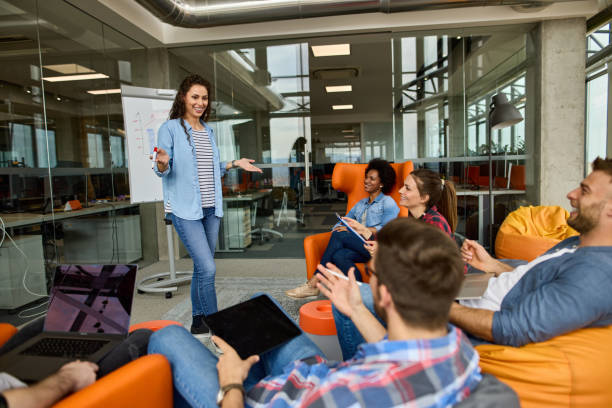 istock Female programmer giving a presentation about new ideas to her colleagues in the office 1343762897
