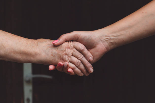 istock Two women shaking hands close up 1343764555