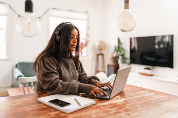 istock Typing on laptop while listening to music 1343765598