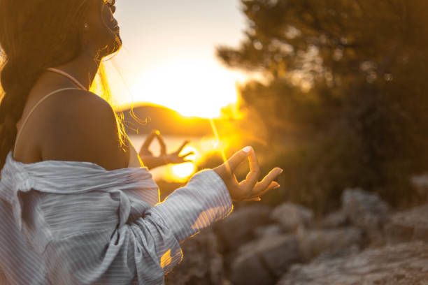 istock Young woman practicing yoga on the beach 1343770960