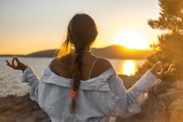 istock Young woman practicing yoga on the beach 1343770972