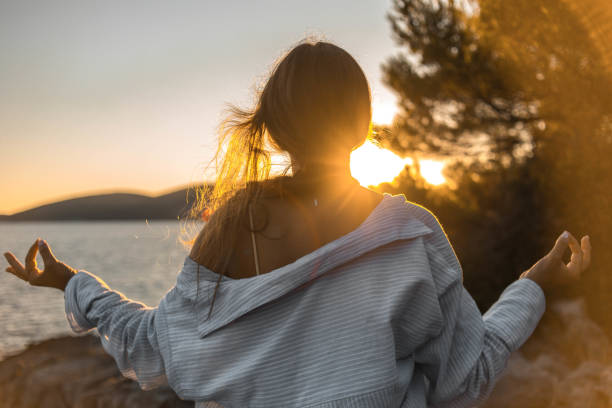 istock Young woman practicing yoga on the beach 1343770974