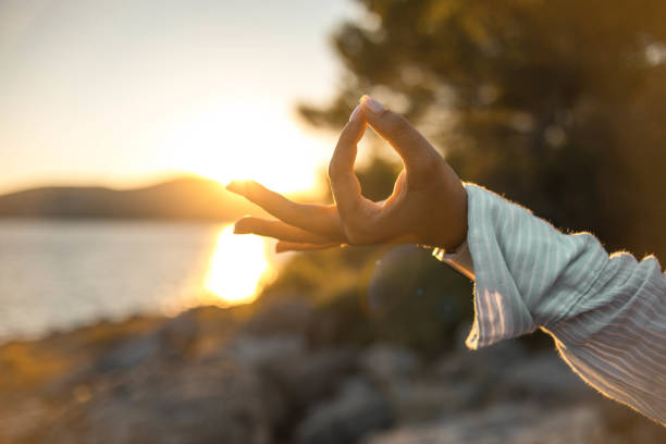istock Young woman practicing yoga on the beach 1343770975