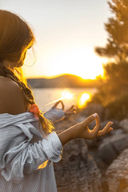 istock Young woman practicing yoga on the beach 1343770996