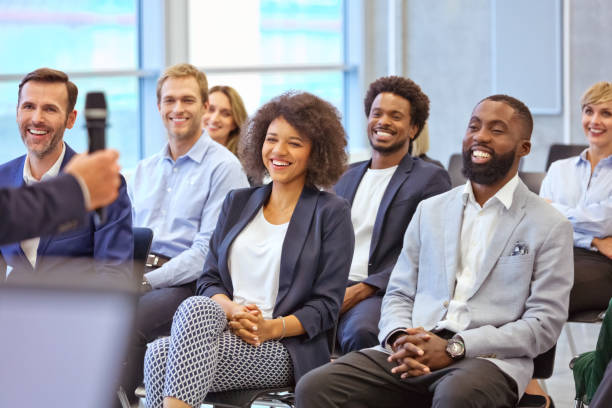 istock Smiling audience during business seminar 1343773054
