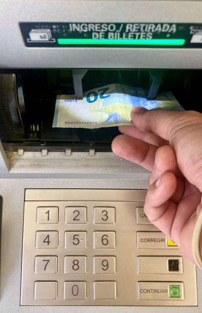 istock Hand withdrawing euro banknotes from an ATM, suffering from inflation 1343773068
