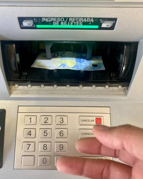 istock Hand withdrawing euro banknotes from an ATM, suffering from inflation 1343773083