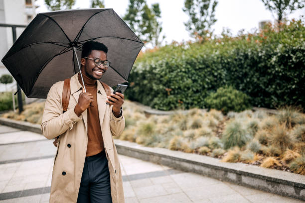 istock Young smiling handsome businessman typing messages on the move 1343774293