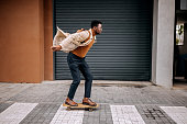 istock Young handsome businessman driving skateboard on the city street 1343774652