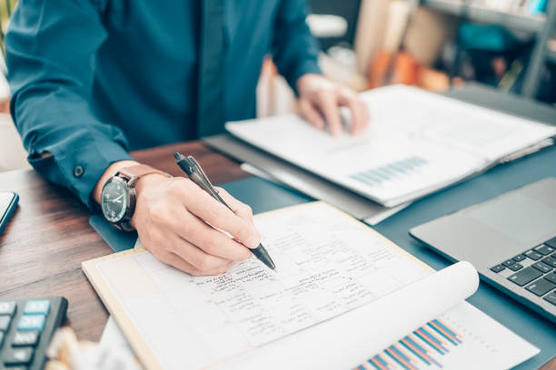 A man hand planning daily appointment and note at office desk. Planner plan Schedule Calendar and reminder. Business planning appointment concept. A man hand planning daily appointment and note at office desk. Planner plan Schedule Calendar and reminder. Business planning appointment concept. deadline stock pictures, royalty-free photos & images